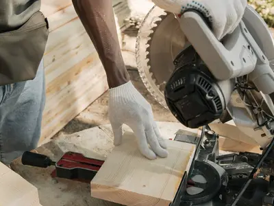 Carpenter cutting timber with a circular saw