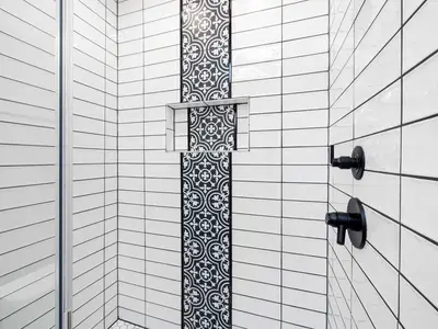 Refitted shower with patterned tiles and black fittings